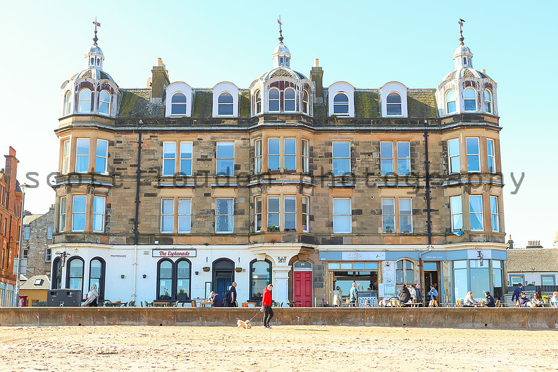 Kevan Christie author portrait on Portobello beach with a rainbow